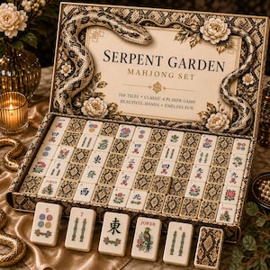 May include: A Serpent Garden Mahjong set in a decorative box with a snake and floral motif. The set includes 160 tiles featuring traditional Chinese characters, floral illustrations, and joker tiles, all arranged in a grid with a snake-patterned border.