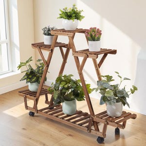 May include: A multi-tiered brown wooden plant stand with a triangular frame and six slatted shelves. The stand features black caster wheels at the base and holds six potted plants with various green foliage and small white, pink, and yellow flowers.