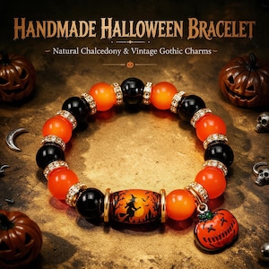 May include: A beaded bracelet featuring alternating black and orange round beads, gold-toned spacers with clear crystals, and a central cylindrical bead depicting a witch silhouette. A small orange pumpkin charm hangs from the bracelet.