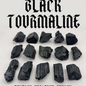 May include: A collection of fourteen raw black tourmaline stones arranged in three rows. The text BLACK TOURMALINE appears at the top, and the text DESTROY NEGATIVE ENERGY appears at the bottom, framed by a chain-link border at the top and bottom.