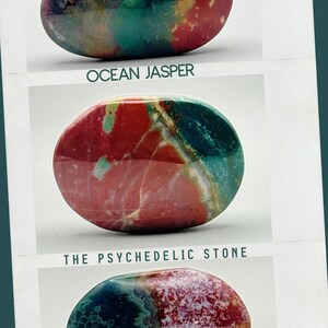 May include: Three polished, oval-shaped ocean jasper stones displayed in a vertical arrangement. The stones feature vibrant, swirling patterns of red, teal, green, and white. Text below the first stone reads OCEAN JASPER and THE PSYCHEDELIC STONE.