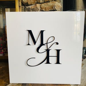 May include: White square box with black letters "M & H" on the front.