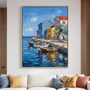 May include: An oil painting on canvas depicting a coastal scene with blue and yellow houses, wooden boats moored at a stone quay, and a tree under a bright blue sky. The artwork features thick, textured brushstrokes and the text OlivicArt.
