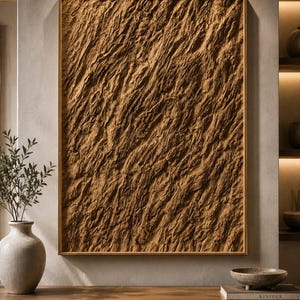 May include: A rectangular wall art piece featuring a thick, textured brown surface with deep, diagonal ridges and grooves, encased in a simple wooden frame. The artwork displays a rugged, organic appearance with varied light and shadow across the surface.