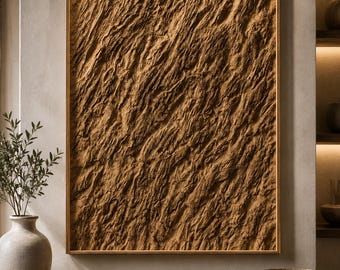 May include: A rectangular wall art piece featuring a thick, textured brown surface with deep, diagonal ridges and grooves, encased in a simple wooden frame. The artwork displays a rugged, organic appearance with varied light and shadow across the surface.