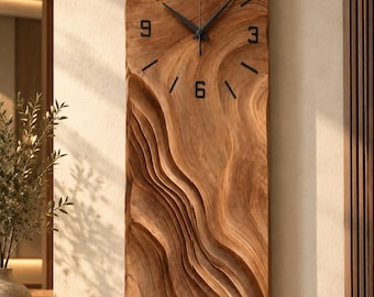 May include: A rectangular wall clock carved from a single piece of light brown wood with a wavy, layered texture. The clock face features black hands and black numerals at the 3, 6, 9, and 12 o'clock positions, with simple black lines marking the remaining hours.