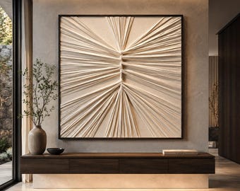 May include: A large square wall art piece featuring a cream-colored textured surface with raised, radiating lines that converge toward a central vertical axis, all encased within a thin, dark brown wooden frame mounted on a neutral wall.