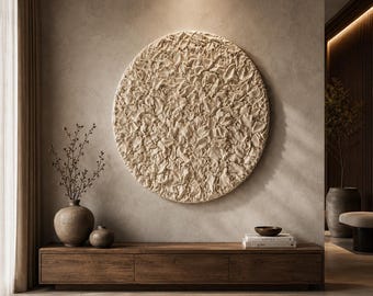 May include: A large circular wall art piece featuring a textured, beige, impasto-style surface with raised, organic, petal-like shapes. The artwork is mounted on a neutral-toned wall above a long, low, dark brown wooden media console cabinet.