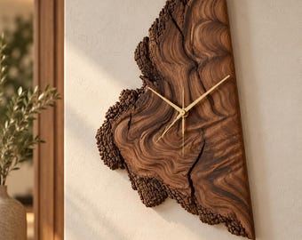 May include: A wall clock crafted from a natural slab of dark brown wood with a live edge, featuring prominent swirling grain patterns, a deep crack, and thin gold-colored metal hands centered on the polished surface.