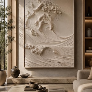 May include: A large rectangular wall art piece featuring a monochromatic cream-colored relief sculpture of a crashing ocean wave. The artwork displays deep textures and swirling patterns that mimic the movement of water, framed in a thin wood border.