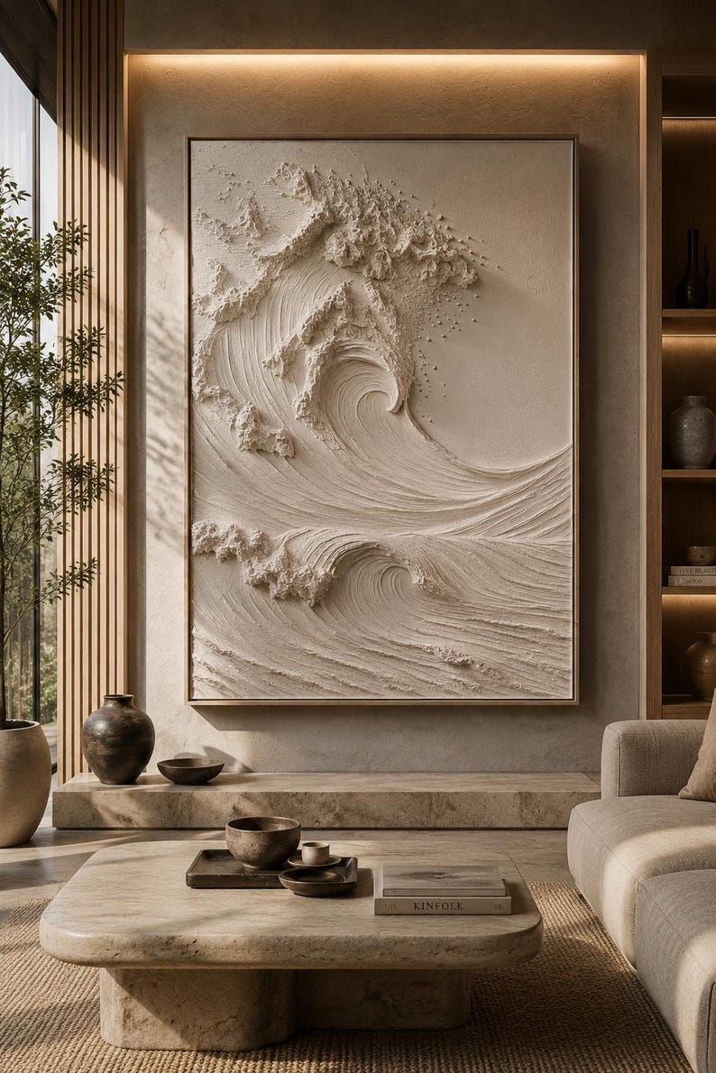 May include: A large rectangular wall art piece featuring a monochromatic cream-colored relief sculpture of a crashing ocean wave. The artwork displays deep textures and swirling patterns that mimic the movement of water, framed in a thin wood border.