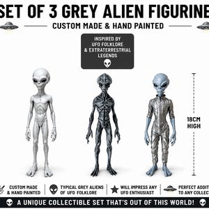 May include: A set of three grey alien figurines, custom made and hand painted. The text reads SET OF 3 GREY ALIEN FIGURINES, CUSTOM MADE & HAND PAINTED, INSPIRED BY UFO FOLKLORE & EXTRATERRESTRIAL LEGENDS, 18CM HIGH, and A UNIQUE COLLECTIBLE SET THAT'S OUT OF THIS WORLD!