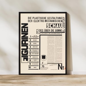 May include: A framed poster featuring black typography on a cream background. The text includes 'FIGURINEN', 'DIE PLASTISCHE GESTALTUNG DER ELEKTRO-MECHANISCHEN SCHAU', 'SIEG ÜBER DIE SONNE', and a numbered list from 1 to 10, alongside a block of small text.