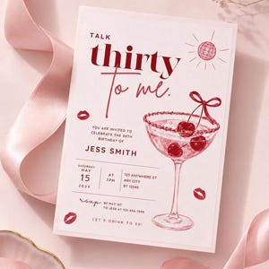 May include: A rectangular birthday invitation card featuring the text Talk thirty to me, a martini glass with cherries, a disco ball, and red lip prints. The card includes event details for Jess Smith on 15 May 2025, at 7pm, with RSVP instructions.