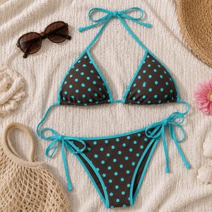 May include: A two-piece bikini set featuring a dark brown fabric with a bright turquoise polka dot pattern. The top has triangle cups with turquoise trim and tie-neck straps, while the bottom features side-tie closures with matching trim.