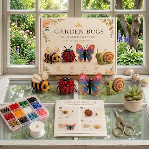 May include: A Garden Bugs DIY beaded craft kit box featuring illustrations of a bee, ladybug, butterfly, and snail. The set includes a clear plastic organizer with colorful beads, a spool of thread, a needle, scissors, and a step-by-step guide.