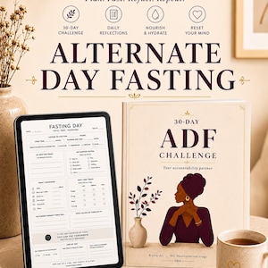 May include: A printable planner for alternate day fasting featuring a tablet displaying a fasting day log, a book titled 30-Day ADF Challenge with an illustration of a person, a speckled mug with a heart, and a gold pen on a neutral surface.
