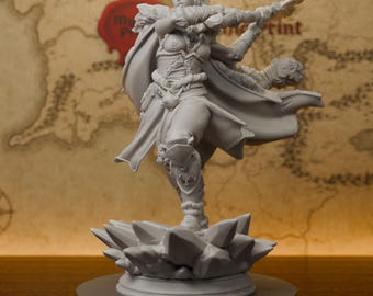 May include: A gray resin miniature figurine of a warrior standing on a crystal-like base. The figure wears fur-trimmed armor and a flowing cape, holding a staff-like weapon in a dynamic pose. The surface is matte gray with intricate details.
