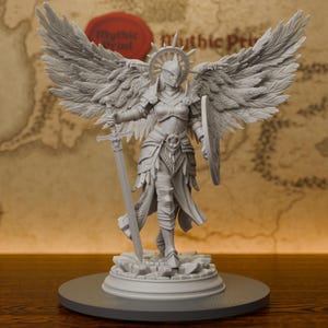 May include: A gray resin miniature figurine of a winged warrior standing on a rubble base. The figure wears ornate plate armor, a spiked halo headpiece, and large feathered wings. It holds a long sword in the right hand and a round shield in the left.