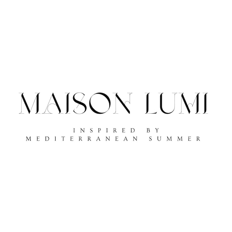 May include: A monochrome logo featuring the words "MAISON LUMI" in a serif font, with "INSPIRED BY MEDITERRANEAN SUMMER" beneath in a smaller sans-serif font. The design is in black on a white background.