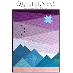 May include: A quilted wall hanging with a mountain landscape design. The quilt features shades of blue, teal, purple, and pink. The finished size is 76 cm x 102 cm. The text "STITCHED BY STARLIGHT QUILTERNESS" is at the top.
