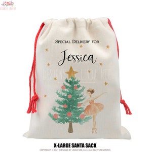 May include: A white canvas drawstring bag with red drawstrings. The bag features a watercolor illustration of a ballerina standing next to a Christmas tree with gold stars. The text "SPECIAL DELIVERY FOR Jessica" is printed on the bag. The bag is labeled "X-LARGE SANTA SACK".