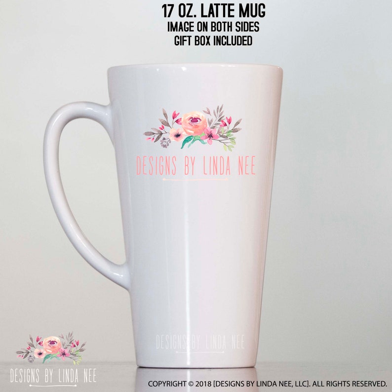 May include: White 17 oz. latte mug with a floral design in pink, peach, and green. The mug has a large handle and the text "DESIGNS BY LINDA NEE" in pink. The image is on both sides of the mug.