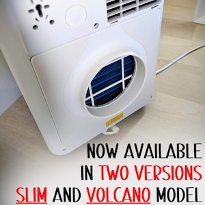 May include: A white portable air conditioner unit featuring a circular exhaust vent with a blue internal filter, a rectangular ventilation grille, and a mounting bracket. The text reads: NOW AVAILABLE IN TWO VERSIONS SLIM AND VOLCANO MODEL.