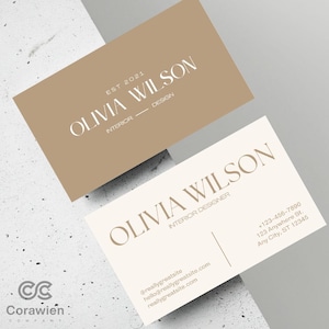 May include: Two rectangular business cards. The top card is tan with white text reading OLIVIA WILSON, EST 2021, and INTERIOR DESIGN. The bottom card is off-white with tan text reading OLIVIA WILSON, INTERIOR DESIGNER, plus contact details.