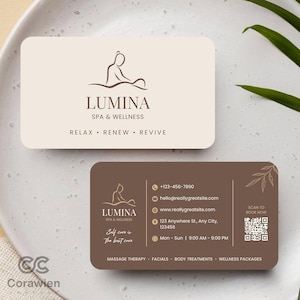 以下が含まれることがあります： Lumina Spa & Wellnessの長方形の名刺2枚。上のカードはクリーム色で、茶色の線画ロゴ、LUMINA SPA & WELLNESSの文字、RELAX • RENEW • REVIVEと記載。下のカードは茶色で、連絡先情報とQRコードが記載されています。