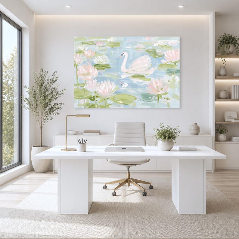 May include: A rectangular wall art print featuring an impressionistic painting of a white swan swimming among pale pink lotus flowers and green lily pads on a light blue water surface, displayed in a bright, modern office space above a desk.