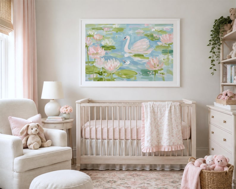 May include: A rectangular wall art print featuring an impressionistic painting of a white swan swimming in a blue pond surrounded by pink water lilies and green lily pads, enclosed in a simple white frame and displayed above a wooden baby crib.