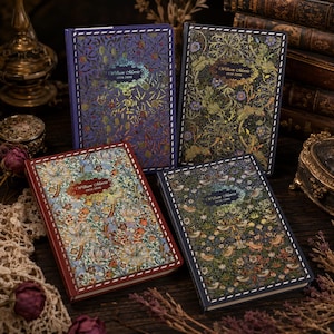 May include: Four rectangular hardcover books featuring intricate William Morris floral and botanical patterns on the covers. Each book displays the text William Morris 1834-1896 in a central decorative frame, with stitched-style borders along the edges.