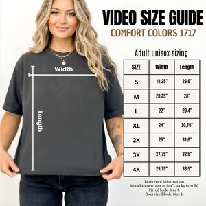 May include: A woman wearing a dark gray Comfort Colors 1717 t-shirt. The image includes a size guide for adult unisex sizing, with measurements in inches. The guide shows sizes S to 4X, with widths from 18.25" to 29.75" and lengths from 26.6" to 33.5".