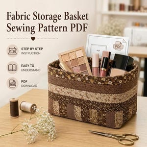 May include: A rectangular fabric storage basket featuring a patchwork design of brown and beige floral and textured patterns. The basket contains makeup items and is displayed with sewing supplies, including thread spools and scissors.