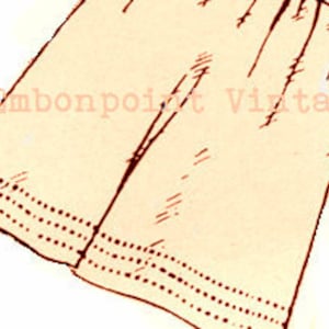 Può includere: Un paio di pantaloncini di cotone bianco con elastico in vita e un bordo decorativo intorno all'orlo inferiore.