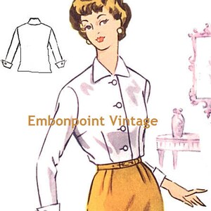 May include: A white blouse with a collar and button closure. The blouse has long sleeves with cuffs and a fitted bodice. The model is wearing a yellow skirt and has her hair styled in a short, curly bob.
