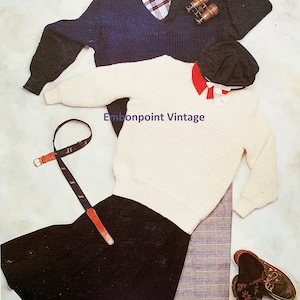 May include: A flat lay of clothing items including a white sweater, a navy blue sweater, a black skirt, a plaid scarf, a brown belt, a black cap, a white shirt with a red collar, and brown shoes. The text "Embonpoint Vintage" is visible in the image.