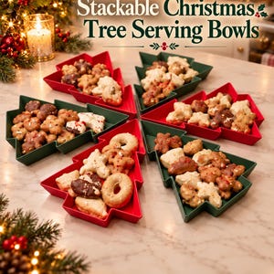 May include: Five Christmas tree-shaped serving bowls in red and dark green, filled with assorted cookies. The text "Stackable Christmas Tree Serving Bowls" is printed above the bowls, which are arranged on a light-colored surface.