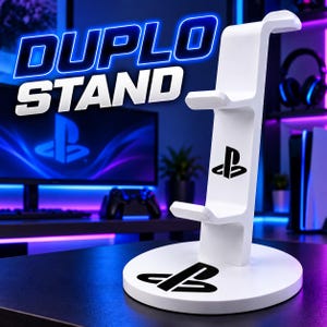 May include: A white vertical gaming controller stand with two tiers for holding controllers. The stand features a circular base and a vertical support arm, both marked with black PlayStation logos. The text DUPLO STAND is visible.
