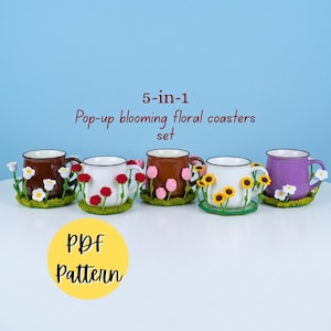May include: A 5-in-1 pop-up blooming floral coasters set PDF pattern featuring five mugs, each resting on a unique crocheted green base adorned with different colorful flowers including white daisies, red roses, pink tulips, and yellow sunflowers.