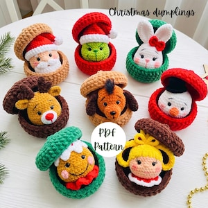 May include: Eight crocheted Christmas dumplings in open containers, featuring characters like Santa, a green creature, a white rabbit, a reindeer, a dog, a snowman, a gingerbread person, and a blonde figure. Text reads Christmas dumplings PDF Pattern.