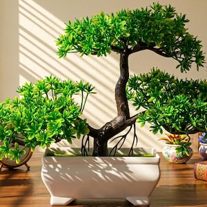 May include: An artificial bonsai tree with vibrant green foliage and a dark brown textured trunk, potted in a rectangular white ceramic container with four small feet. The plant features multiple branches extending outward with dense clusters of leaves.