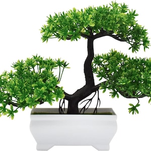May include: A small artificial bonsai tree with vibrant green plastic foliage and a dark brown textured trunk. The tree is planted in a rectangular white plastic pot with four small feet at the base, creating a clean and simple decorative display.