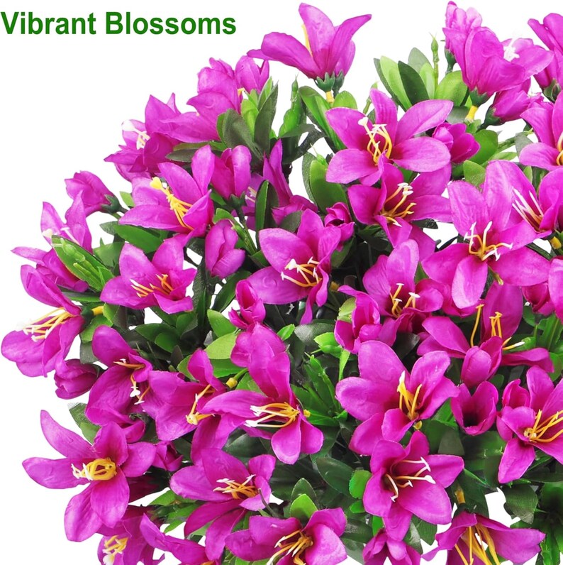 May include: A cluster of artificial flowers with vibrant magenta petals and yellow stamens, interspersed with green leaves. The text "Vibrant Blossoms" is printed in green in the upper left corner of this floral arrangement.