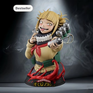 May include: A detailed figurine of a female anime character with blonde hair, yellow eyes, and a mischievous expression. She wears a tan sweater, a red scarf, and a black skirt. The base features text from the My Hero Academia series.