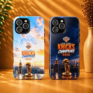 May include: Two phone cases with a New York Knicks theme. One case has a blue and orange sunset design with the text "Knicks Champions 2026". The other case has a dark blue background with the same text and a trophy.