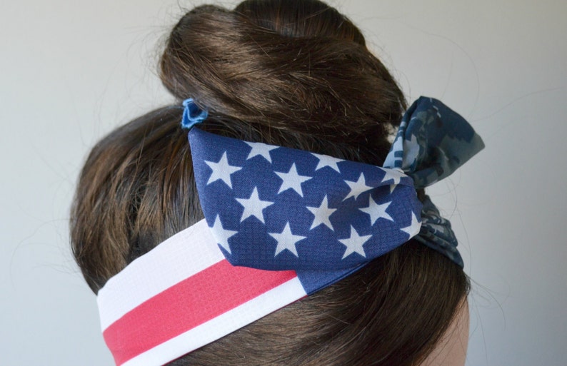 May include: A red, white and blue headband with a star-patterned fabric. The headband is tied in a bow at the back of the head.