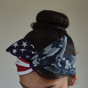 May include: A headband with a blue and white camouflage pattern on one side and a red, white and blue American flag pattern on the other side.