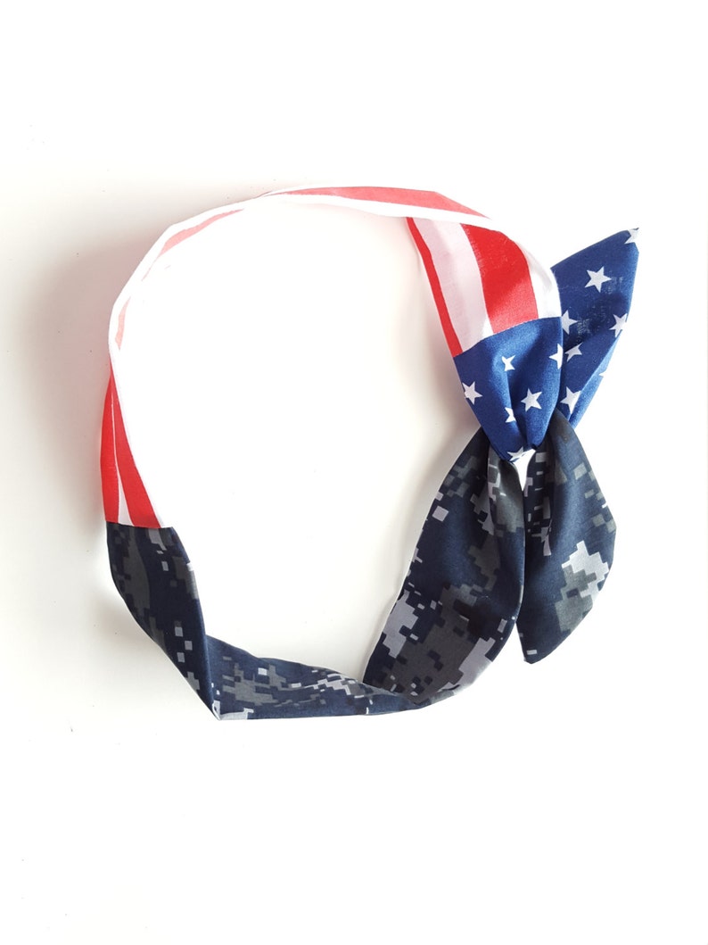 May include: A blue and white headband with a red, white and blue American flag design. The headband is tied in a knot at the top.